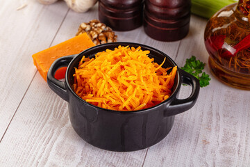 Yellow shredded cheddar cheese in the bowl