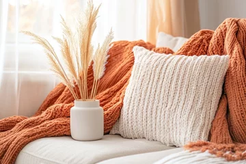 Selbstklebende Fototapeten Cozy autumn scene with pampas grass and knitted throws © innova
