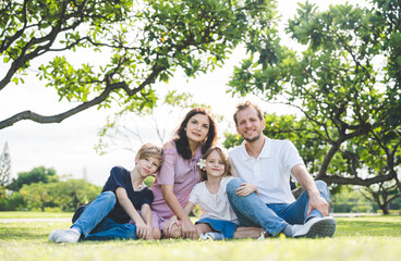 Fototapeta premium Happy family parent children having picnic outdoor activity. Enjoy happiness moment summer playing together including father mother son and daughter relaxing in the morning sunrise.