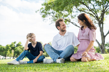 Fototapeta premium Happy family parent children having picnic outdoor activity. Enjoy happiness moment summer playing together including father mother son and daughter relaxing in the morning sunrise.
