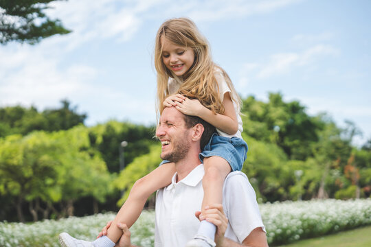 Happy family parent children having picnic outdoor activity. Enjoy happiness moment summer playing together including father mother son and daughter relaxing in the morning sunrise.