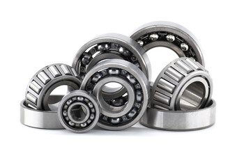 Assortment of various bearings isolated on a clean white backdrop, close up details.