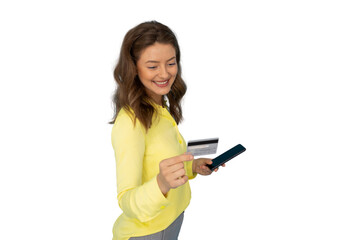 Smiling shopper paying online, holding credit card and smartphone against clear backdrop