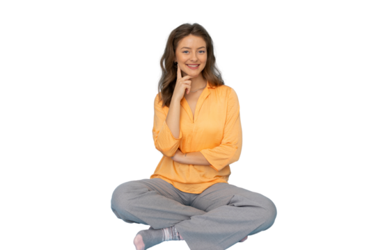 Contemplative woman seated cross-legged, hand resting on chin, gentle smile against transparent backdrop - Powered by Adobe