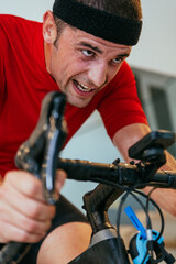 A triathlete riding a triathlon bike on a machine simulation in a modern living room. Training...