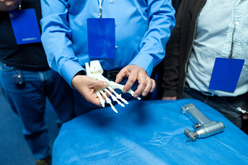 Prosthetic hand demo. A person shows a prosthetic hand model to an audience at a technology...