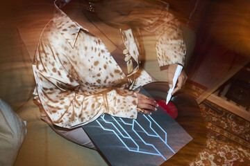 Blurred motion of musician putting an autograph on music record during podcast in studio