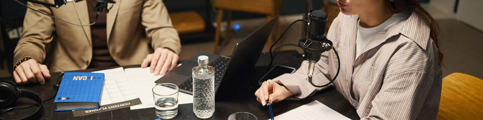 Header with woman discussing book with man during podcast
