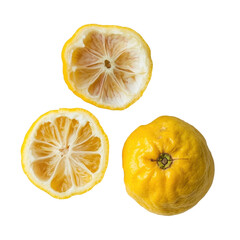 Yellow lemons with one sliced open revealing the interior texture in a clean white background