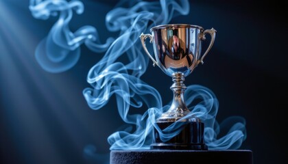dramatic close up of polished silver trophy on black pedestal swirling blue tinged smoke curling at its base low angle shot focuse