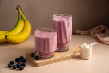 Banana blueberry protein smoothie in a glass.