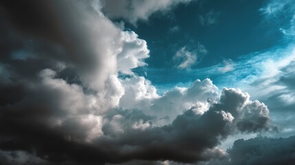 Obraz premium Dramatic clouds fill the sky as sunlight breaks through, creating a contrast with the deep blue backdrop.
