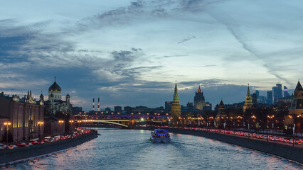 Naklejka premium Ensemble of Moscow Kremlin and Moskva-City business center view across Moskva river at a winter day to night timelapse hyperlapse