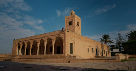 Great Moslem Mosque on territory medieval fortress Ribat in Monastir, Tunisia. Colonnade with arches on territory mausoleum Bourguiba in Monastir city.