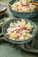 Cold cauliflower salad withradish, red onions and chives