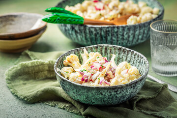 Cold cauliflower salad withradish, red onions and chives
