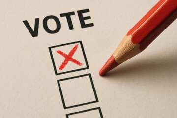 Voting Process With Red Pencil Marking a Choice on a Ballot During an Election