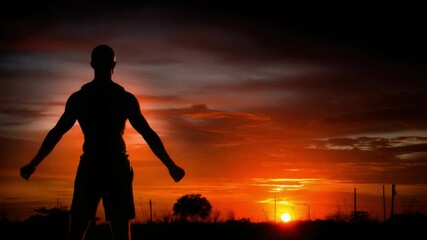 Man Silhouette Sunset: A muscular man silhouette stands with arms outstretched against a vibrant sunset, conveying strength, freedom, and contemplation. 