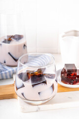 Homemade milky tea jelly, cold summer drink with black tea jelly and tea milk. Thai style iced cocktail, copy space