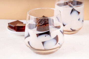 Homemade milky tea jelly, cold summer drink with black tea jelly and tea milk. Thai style iced cocktail, copy space