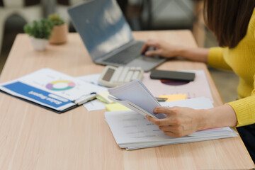 Woman Analyzing Financial Reports at Desk