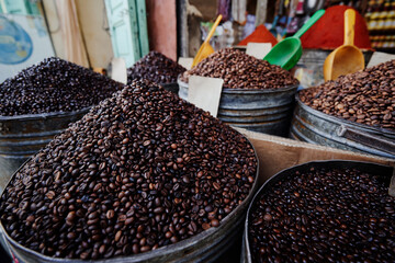 Assorted Roasted Coffee Beans Displayed in Metal Buckets at a Morocco Market..