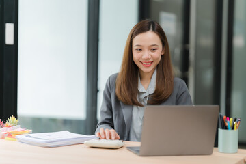 Smiling Asian Woman Working at Desk