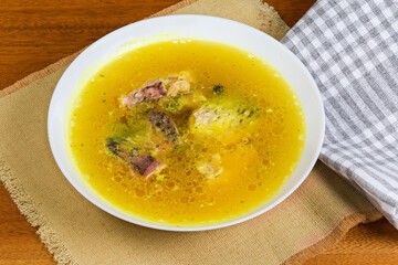 Serving of jellied fish in the white dish on table