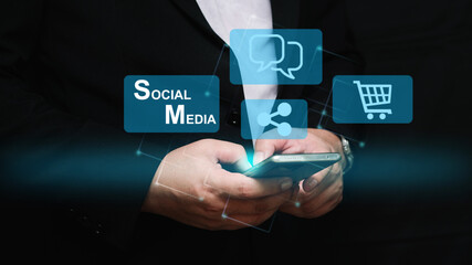 Businessman using smartphone with floating social media, chat, and shopping icons. Concept of digital communication, e-commerce, and online marketing strategy.