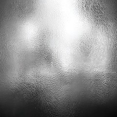 A close-up of finely textured, frosted glass that creates a soft grainy effect throughout the composition. The glass appears almost metallic due to its silvery tone.