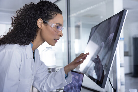 Woman scientist Engaging with Research Data on Screen