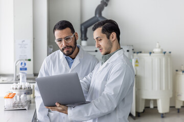 Medical student showing data on a Laptop to his teacher