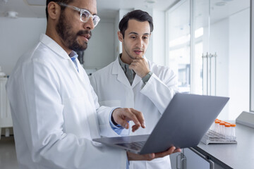 Scientists Colorating Over a Laptop in a 