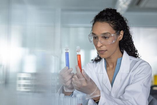 Female scientist Holding Chemical Test Tubes in oratory