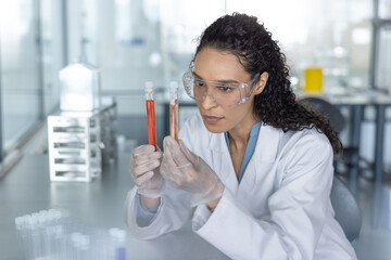 Scientist analyzing red liquid in test tubes