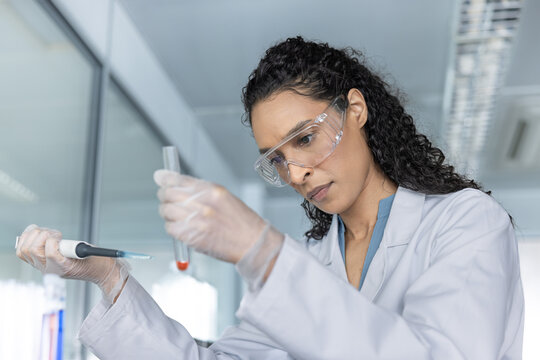 Scientist using pipette for liquid transfer