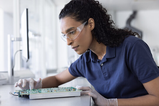 Technician Working on Advanced Circuit Board