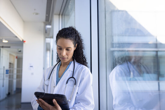 Doctor using digital tablet for work in quiet Hospital Room