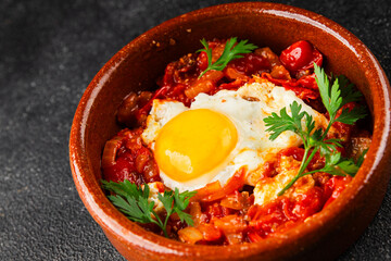 Fried egg tomatoes shakshuka vegetable dish appetizer fresh delicious gourmet food background on the table rustic food top view copy space vegetarian  food