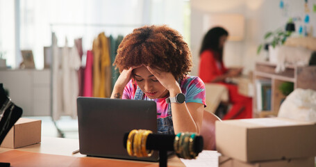 Woman, fashion designer and laptop with stress at workshop for order, frustrated or 404 glitch....