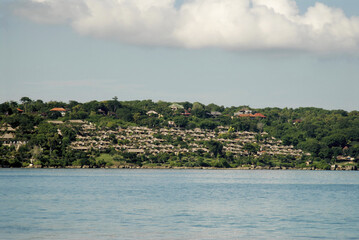 Scenic coastal view of bali seashore with tropical resort and lush greenery