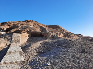  The mountains surrounding the historic ruins of Madyan Shuaib offer a stunning view. Madyan Shuaib is an archaeological site in the Al Bad Governorate of the Tabuk region in Saudi Arabia.