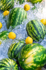 watermelons and lemons are covered with ice cubes