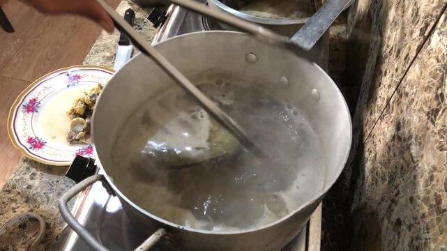 Placuna saddle oysters, also known as windowpane or capiz oysters, are soaked in hot boiling water so that the meat falls out on its own