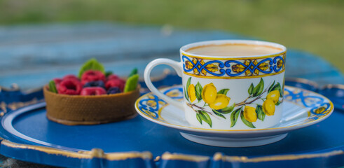 Lemon tea cup and dessert on blue tray, cozy lifestyle setting