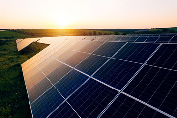 Aerial view of a solar farm generating solar energy.Solar panels park generating green energy electric at sunset.Green energy reduce carbon emissions and makes earth cleaner and more ecological.	
