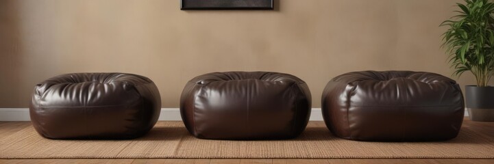 Obraz premium Two vintage black poufs add texture to a trendy brown leather couch living room , furniture, black pouf