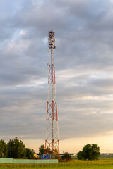 Sunset over rural farmland with cell tower