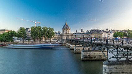 Fototapeta premium People walk on the Bridge of Arts over the River Seine to the Institute of France timelapse hyperlapse - Paris, France