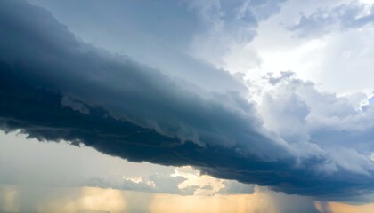 Obraz premium Dramatic storm cloudscape with rain and sunlight breaking through.